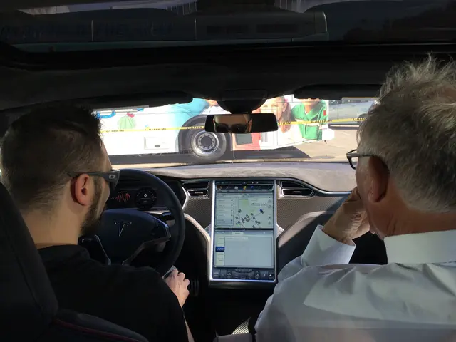 The image is taken from inside a car,two people are sitting in the front seat and the left side...