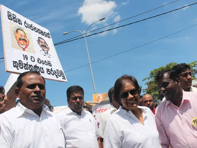 In this image we can see men are standing and protesting by holding banners. We can see poles,...